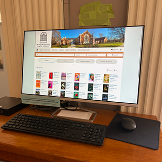 Photograph of a computer monitor displaying library catalog searches