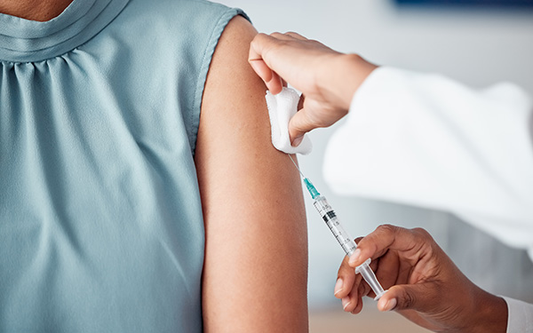 Graphic showing closeup of an arm getting a vaccine shot